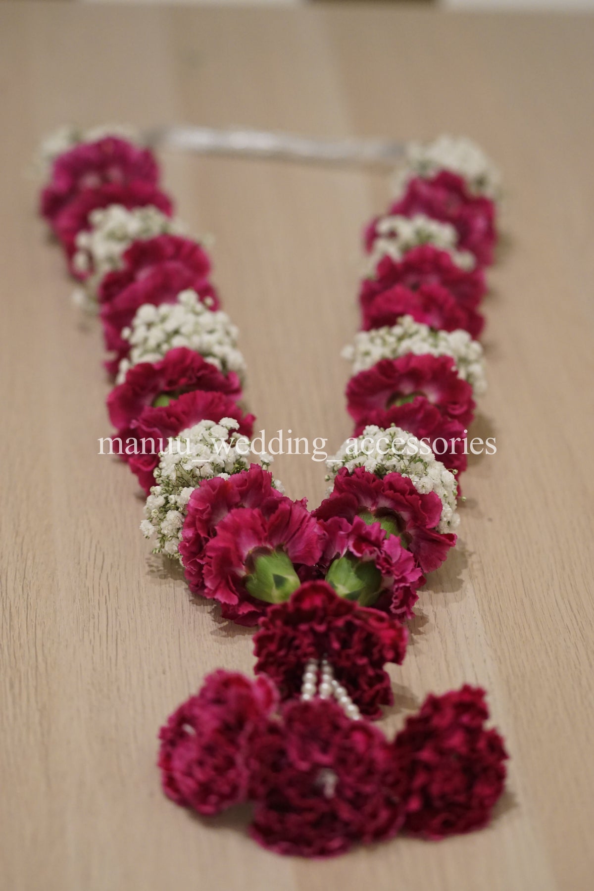 Red carnations and baby's breath garland
